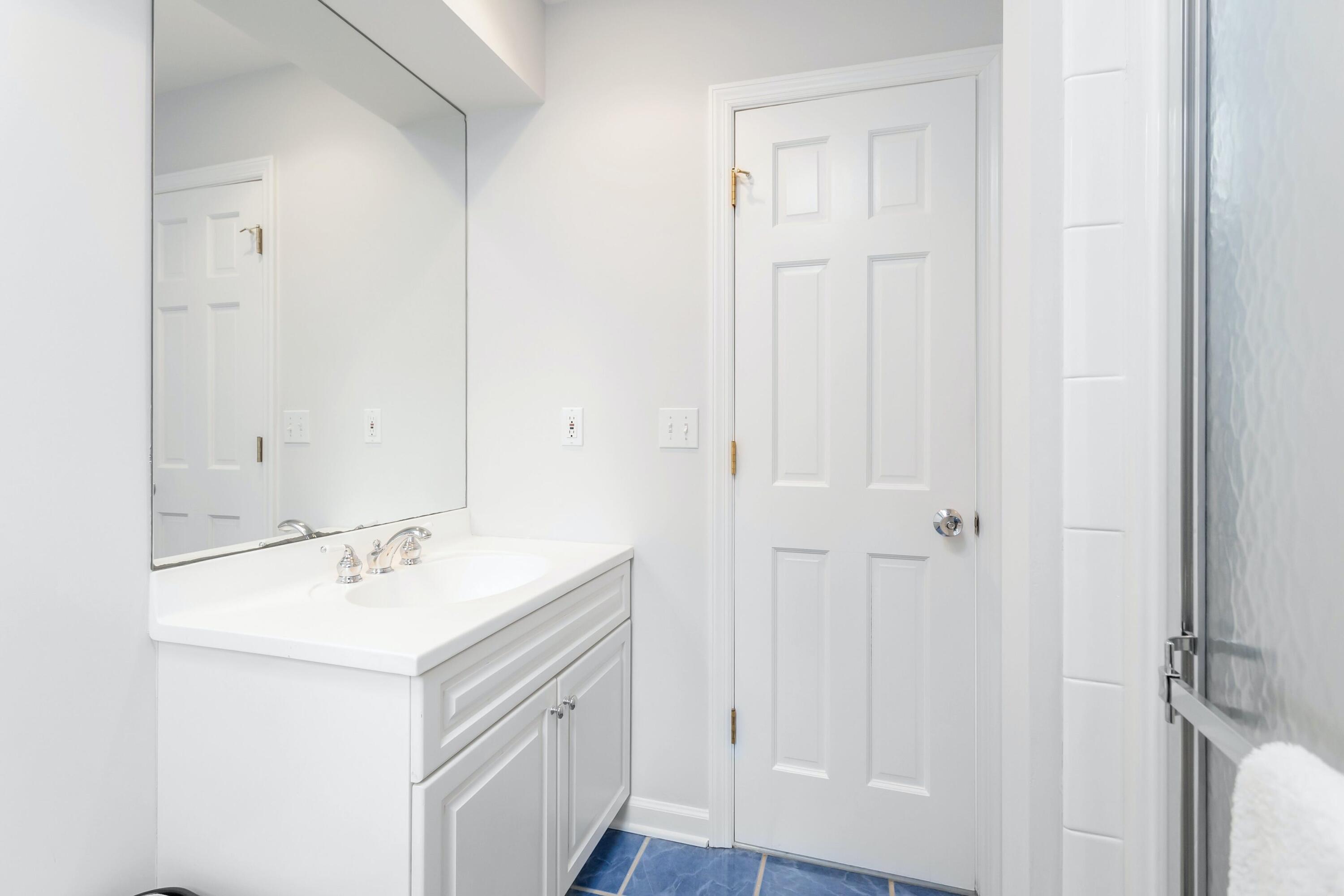 21 Revere Road Darien, CT 06820 - Photo 32 of 40 a bathroom with a sink mirror and vanity