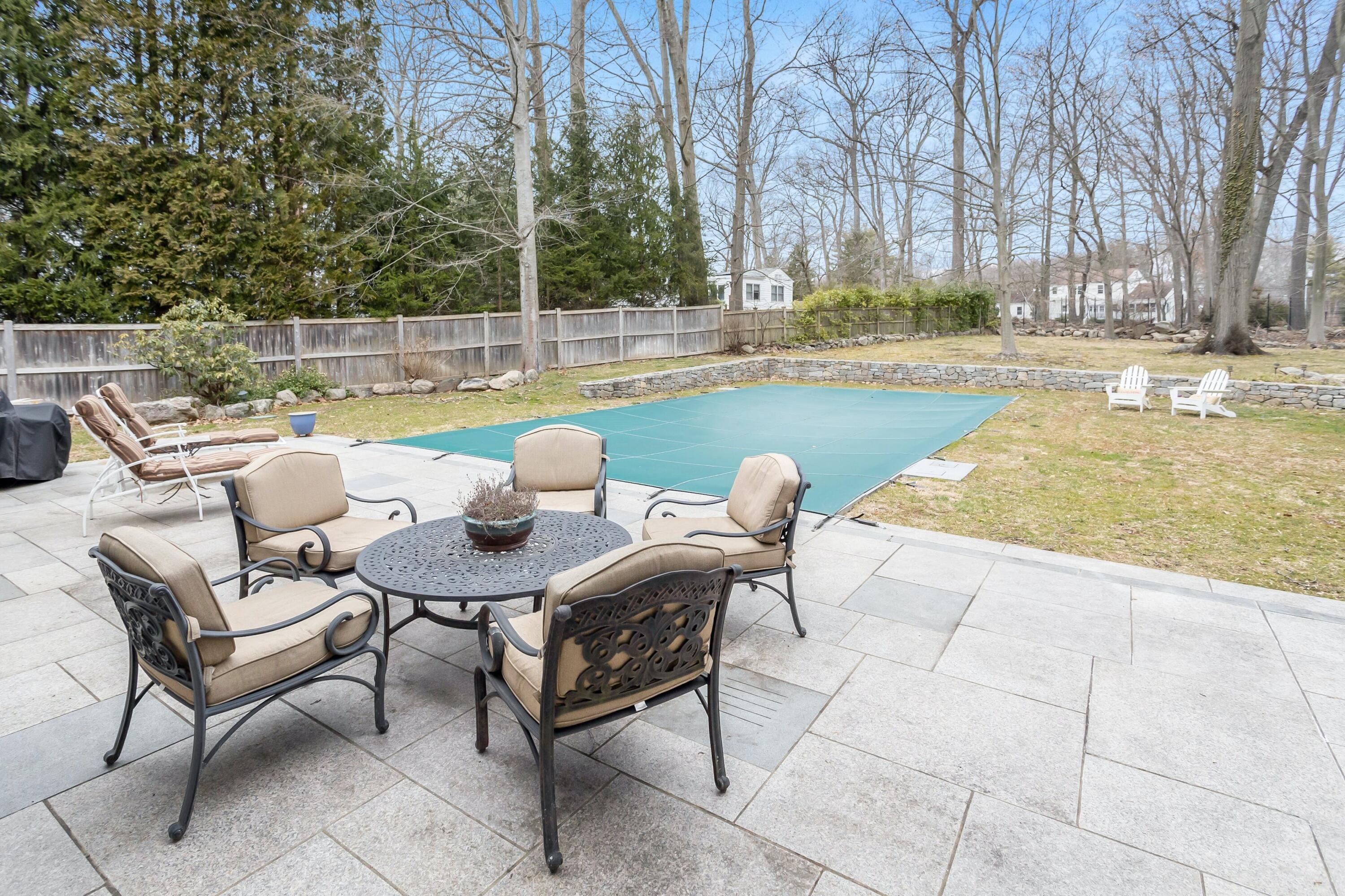21 Revere Road Darien, CT 06820 - Photo 36 of 40 a swimming pool with outdoor seating and yard