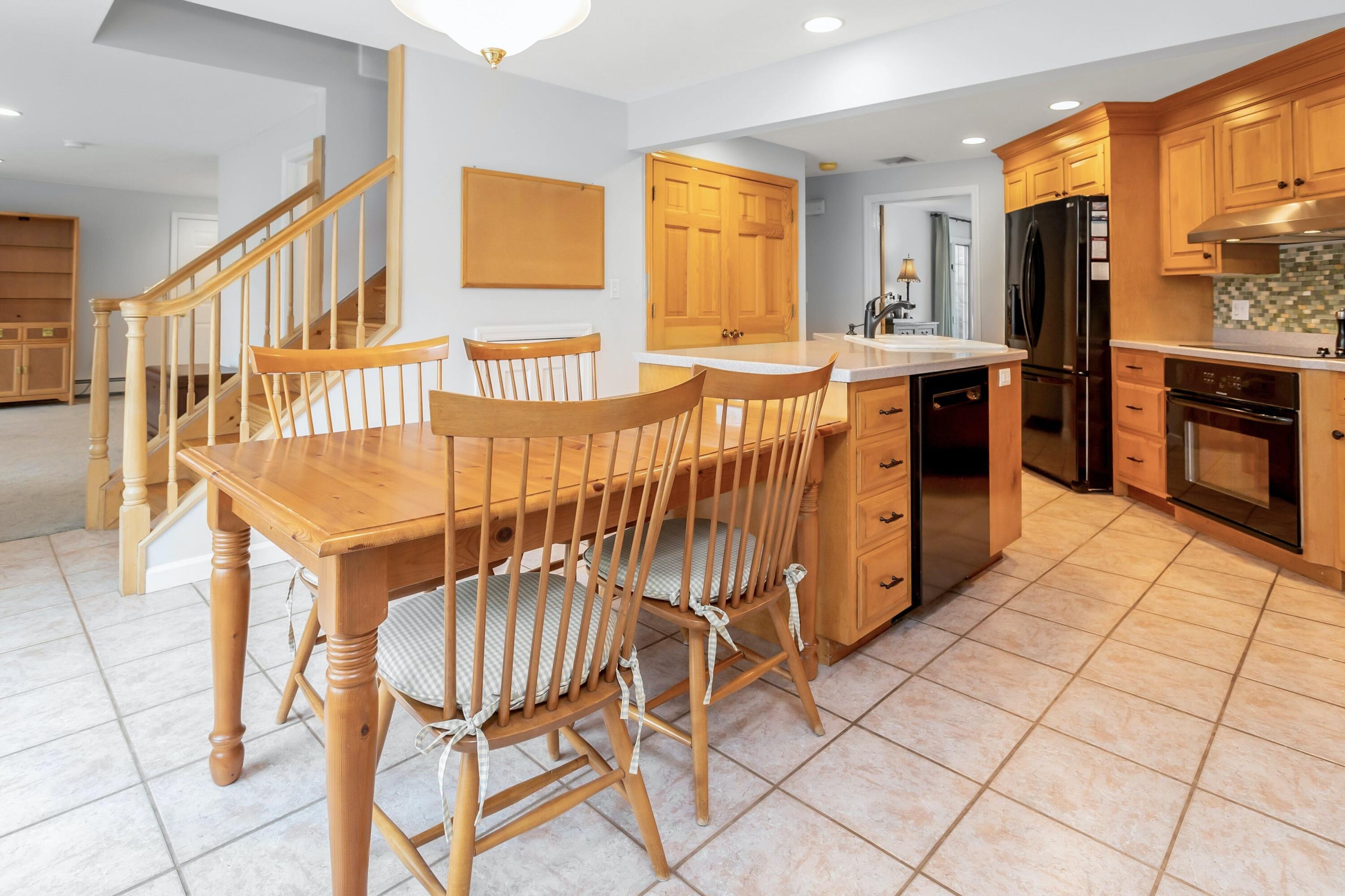 21 Revere Road Darien, CT 06820 - Photo 9 of 40 a kitchen with stainless steel appliances kitchen island granite countertop a stove a sink a dining table and chairs