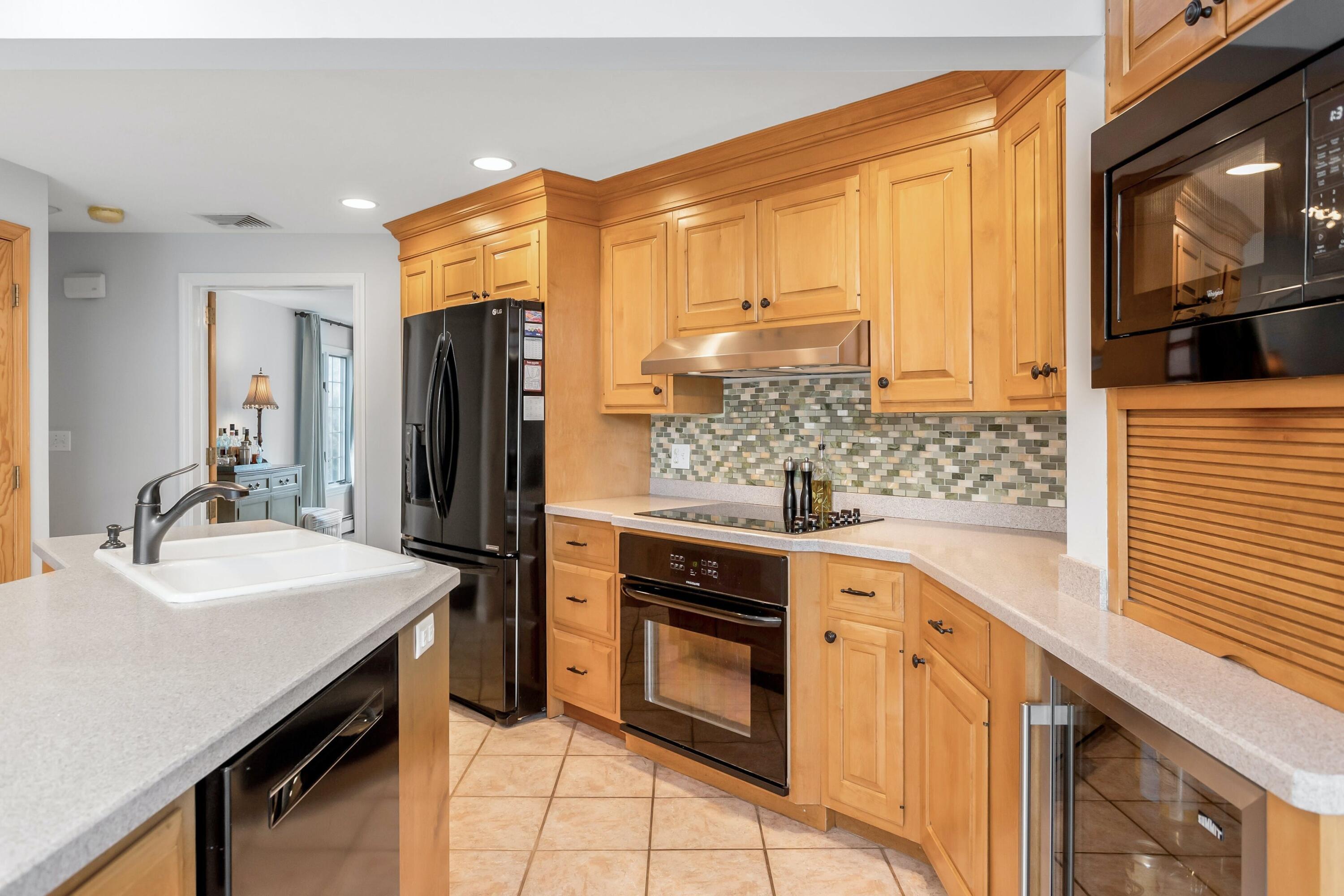21 Revere Road Darien, CT 06820 - Photo 10 of 40 a kitchen with stainless steel appliances kitchen island granite countertop a sink stove and refrigerator