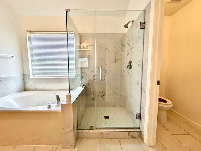a bathroom with a shower and a bathtub