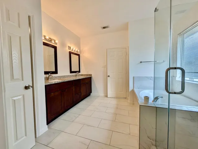a bathroom with a sink a toilet and mirror