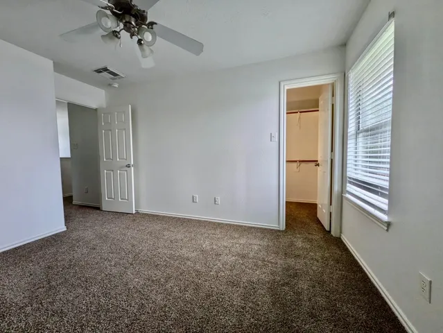 an empty room with a empty space and chandelier fan