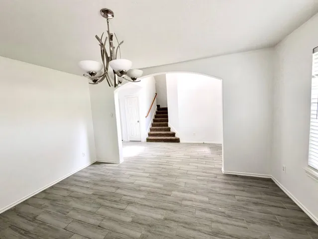 a view of a room with wooden floor and stairs