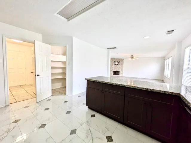 a spacious bathroom with a granite countertop sink and a mirror