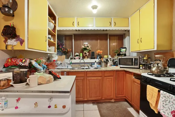 a kitchen with a sink a stove and cabinets