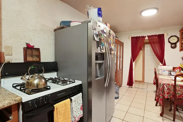 a kitchen with stainless steel appliances granite countertop a refrigerator and a stove