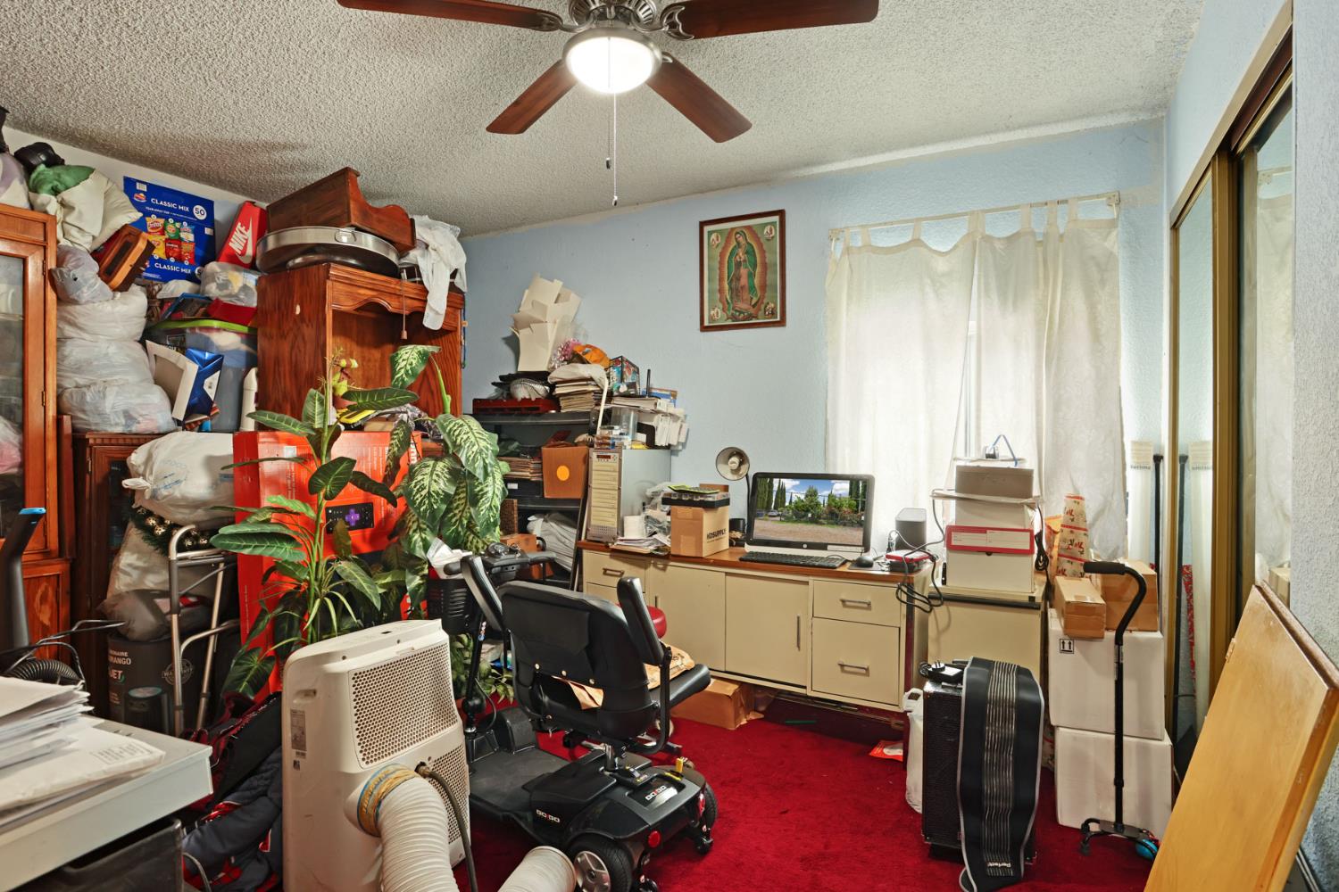 202 Olivero Road Modesto, CA 95358 - Photo 19 of 36 a view of a workspace with furniture and a window