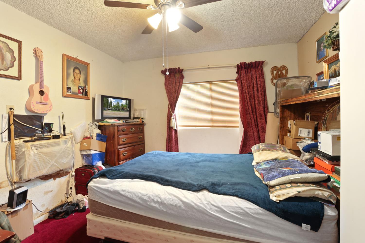 202 Olivero Road Modesto, CA 95358 - Photo 20 of 36 a bedroom with a bed and a chandelier
