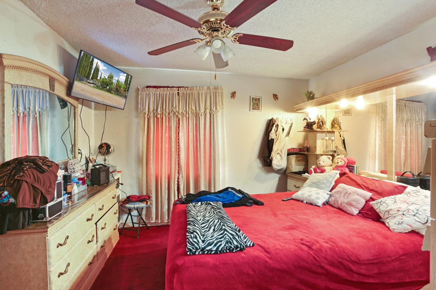 202 Olivero Road Modesto, CA 95358 - Photo 22 of 36 a bedroom with a bed and a chandelier