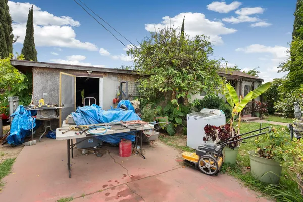 a view of a chairs and tables in the back yard of the house