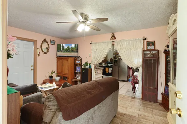 a living room with furniture and a chandelier