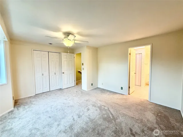 a spacious bathroom with a double vanity sink a mirror and a toilet