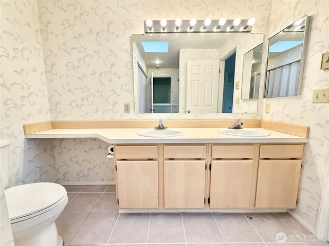 a bathroom with a tub a sink and a mirror