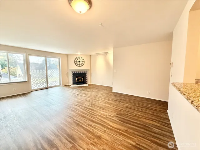 a view of a livingroom with a fireplace and window