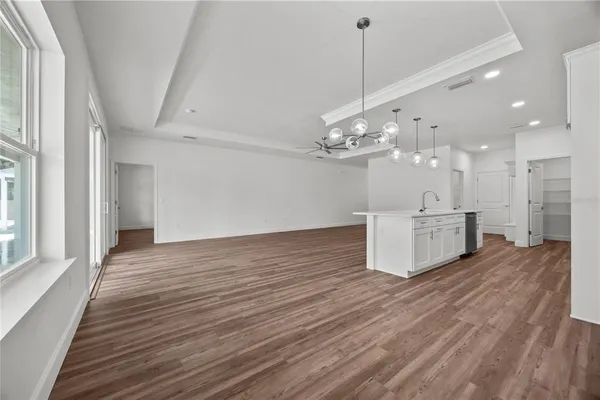 a view of a kitchen with a sink and wooden floor