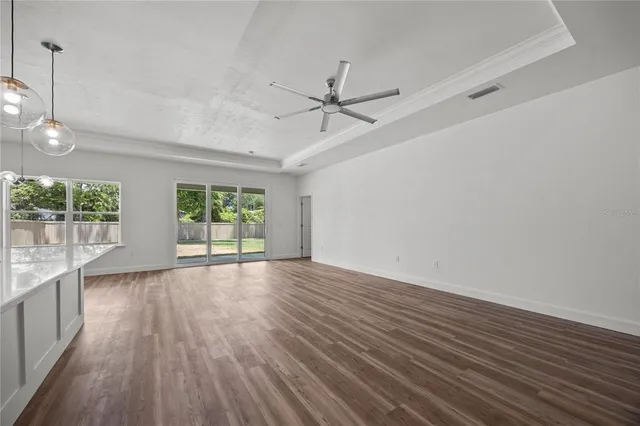 a large white kitchen with lots of counter space sink and cabinets
