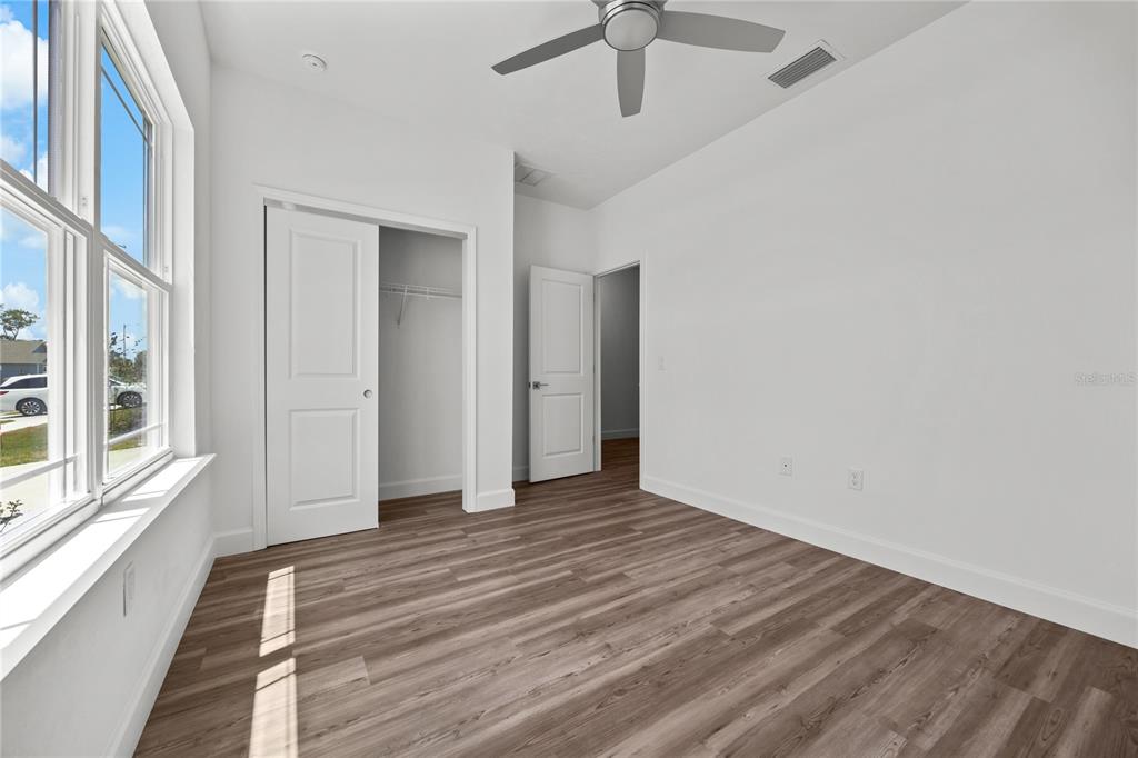 1100 Southwest 67th Drive Gainesville, FL 32607 - Photo 20 of 27 a view of an empty room with wooden floor and a window