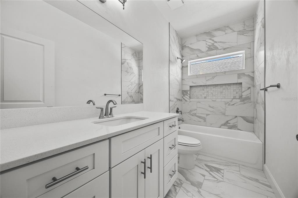 1100 Southwest 67th Drive Gainesville, FL 32607 - Photo 21 of 27 a bathroom with a sink a toilet and shower