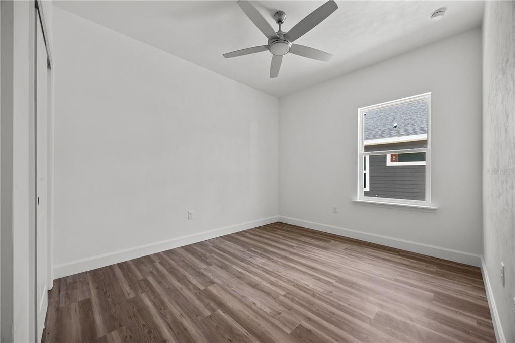 1100 Southwest 67th Drive Gainesville, FL 32607 - Photo 22 of 27 a view of an empty room with a window and wooden floor