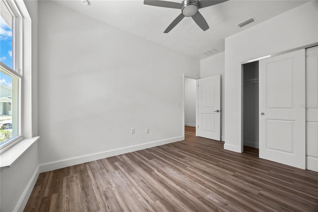 1100 Southwest 67th Drive Gainesville, FL 32607 - Photo 23 of 27 an empty room with wooden floor and windows