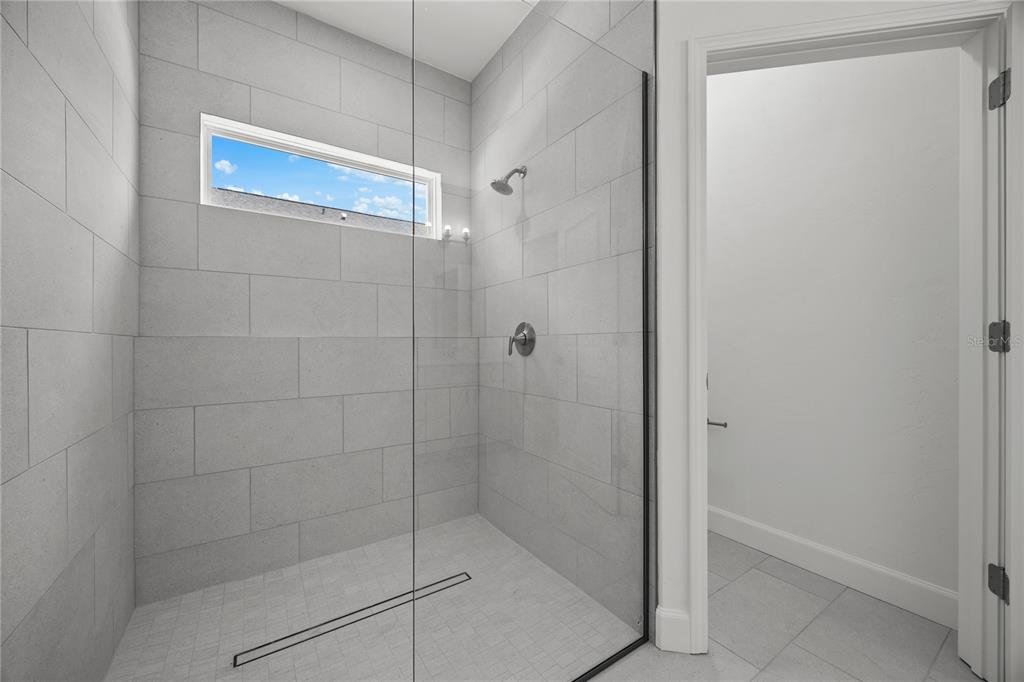 1100 Southwest 67th Drive Gainesville, FL 32607 - Photo 7 of 27 a bathroom with a glass door shower