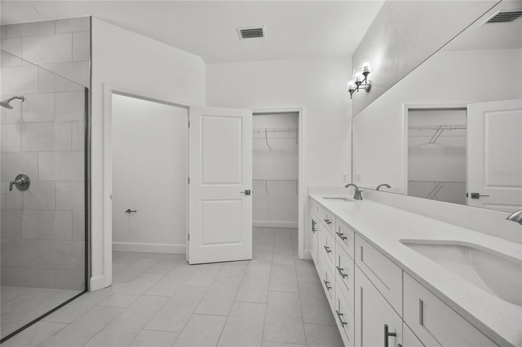 1100 Southwest 67th Drive Gainesville, FL 32607 - Photo 8 of 27 a spacious bathroom with a double vanity sink a mirror and a shower