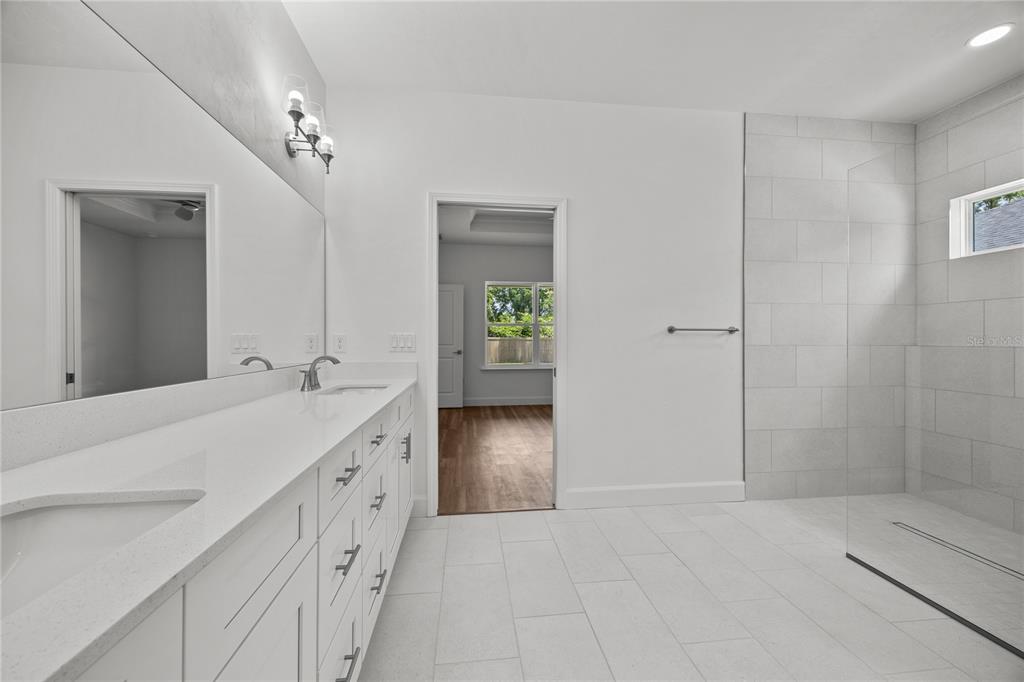 1100 Southwest 67th Drive Gainesville, FL 32607 - Photo 10 of 27 a bathroom with a double vanity sink and a mirror