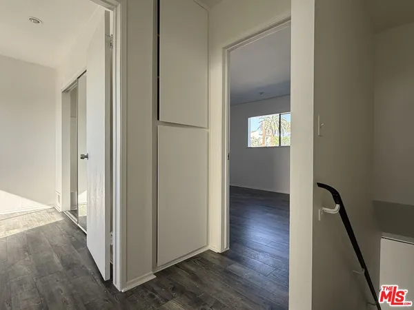 a view of hallway with stairs and wooden floor