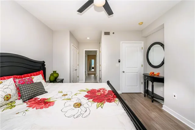 a bedroom with a bed and a chandelier