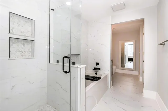 a bathroom with a tub and shower