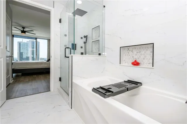 a living room with stainless steel appliances furniture and a window