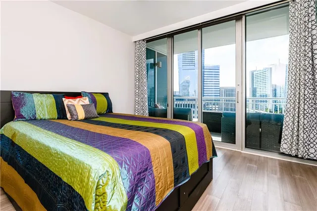 a bedroom with a bed and a large window