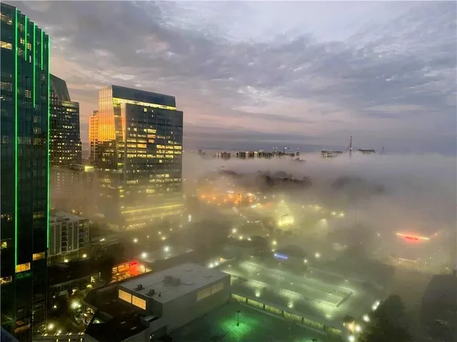a view of a tall building next to a city