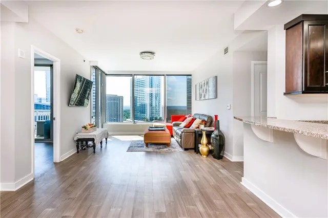 a living room with furniture and wooden floor