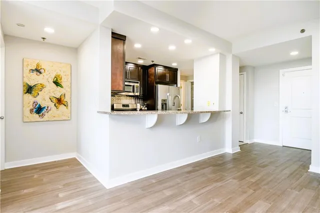 a view of a kitchen with wooden floor and a sink
