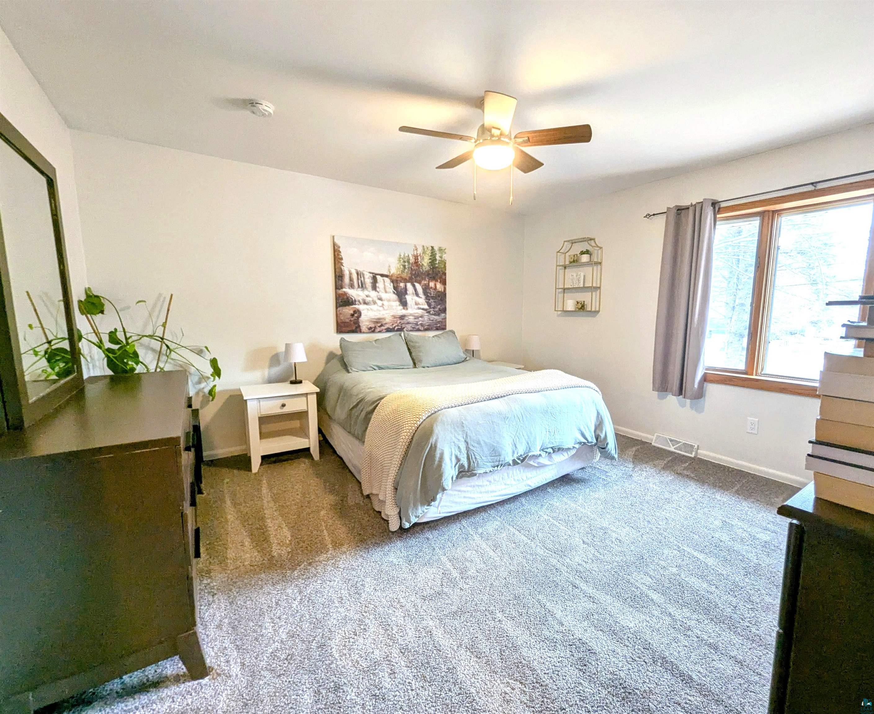 3321 Decker Road Duluth, MN 55811 - Photo 11 of 31 Carpeted bedroom featuring visible vents, baseboards, and a ceiling fan