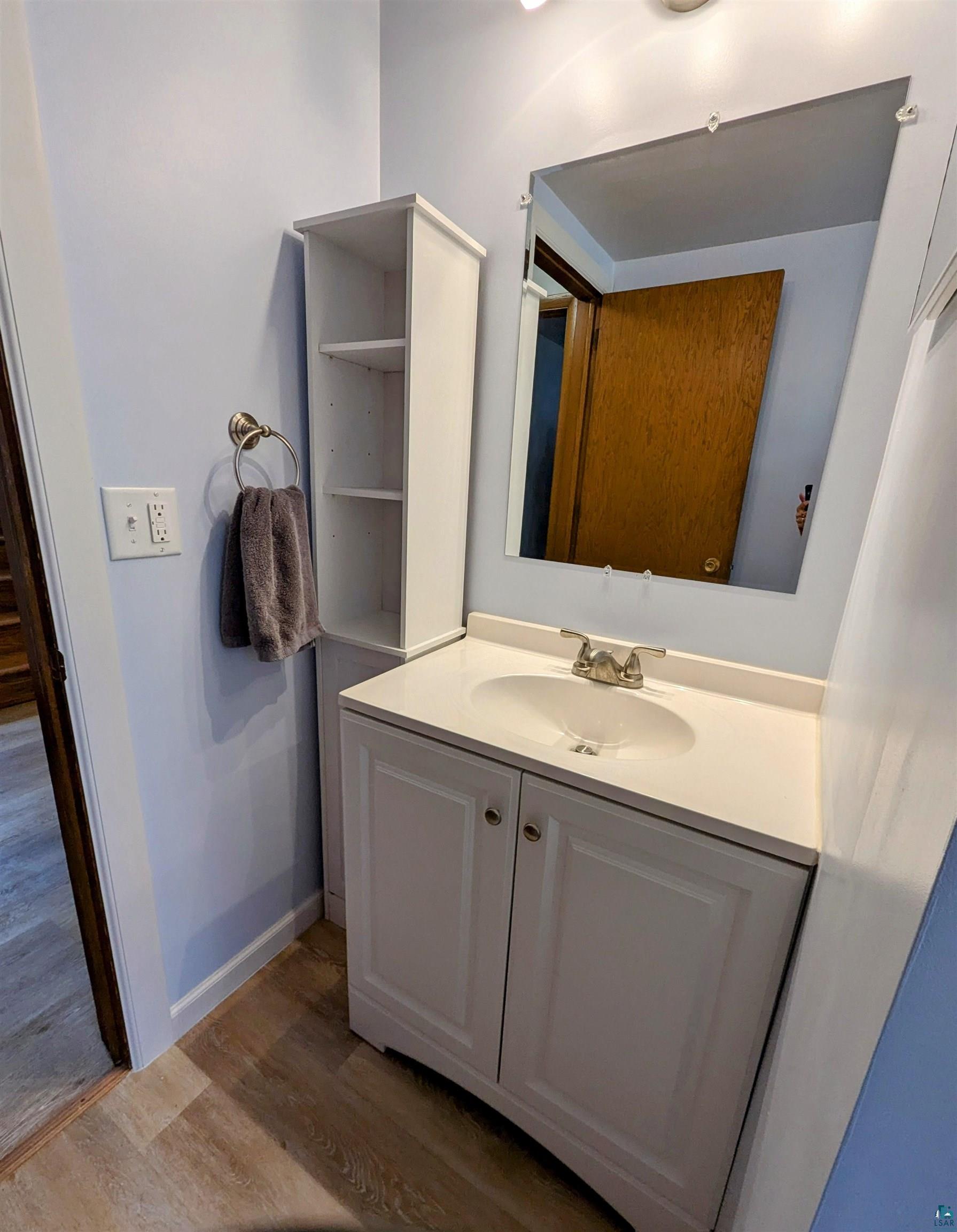 3321 Decker Road Duluth, MN 55811 - Photo 26 of 31 Bathroom with vanity, wood finished floors, and baseboards