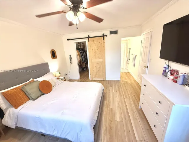 a bedroom with a bed couch and a window