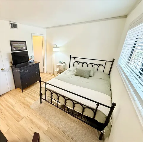 a bedroom with a bed a couch and dresser