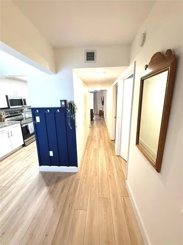 a kitchen with stainless steel appliances granite countertop a stove a sink dishwasher and a refrigerator