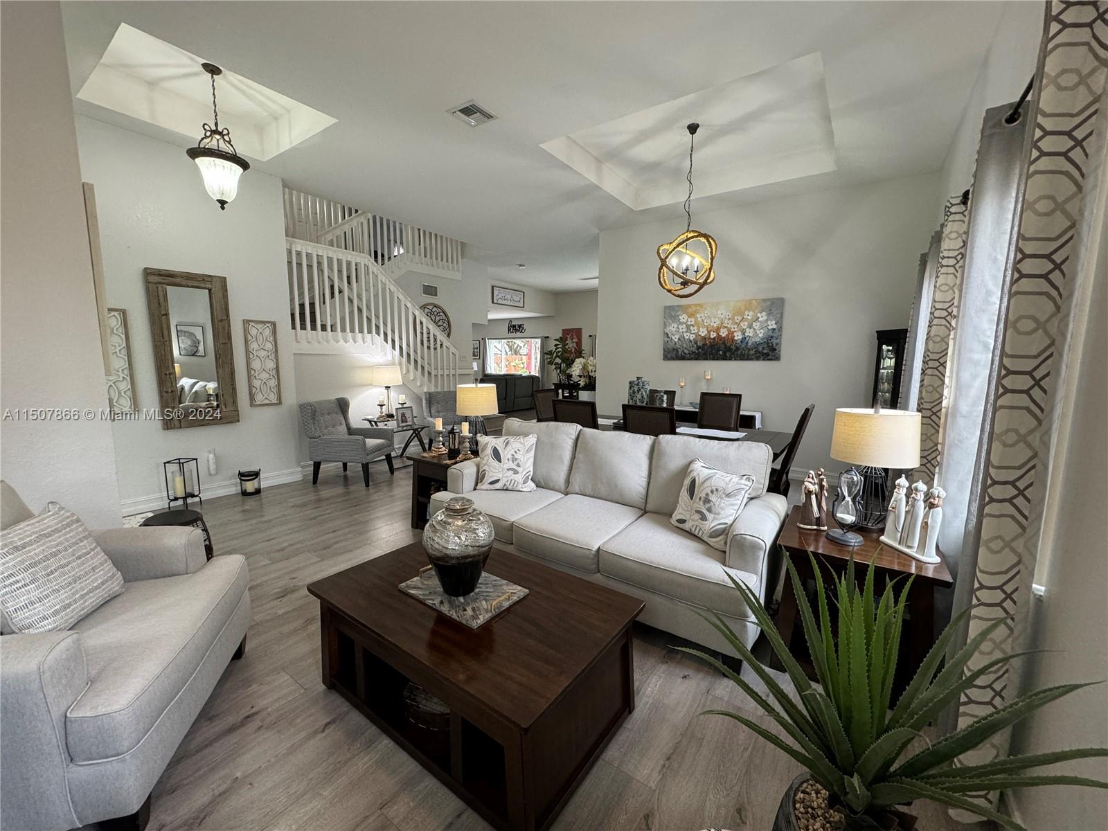 2006 Northeast 38th Road Homestead, FL 33033 - Photo 36 of 80 a living room with furniture a chandelier and a chandelier