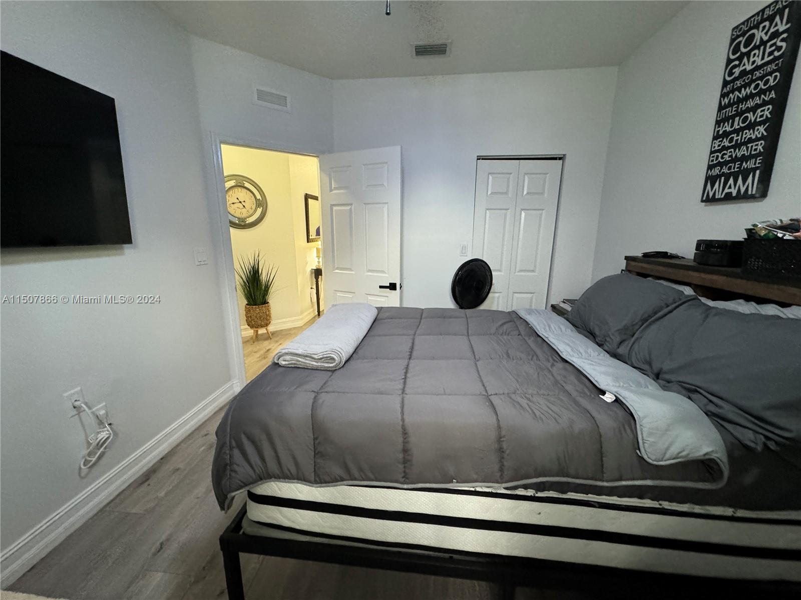 2006 Northeast 38th Road Homestead, FL 33033 - Photo 54 of 80 a bedroom with a bed and a flat screen tv