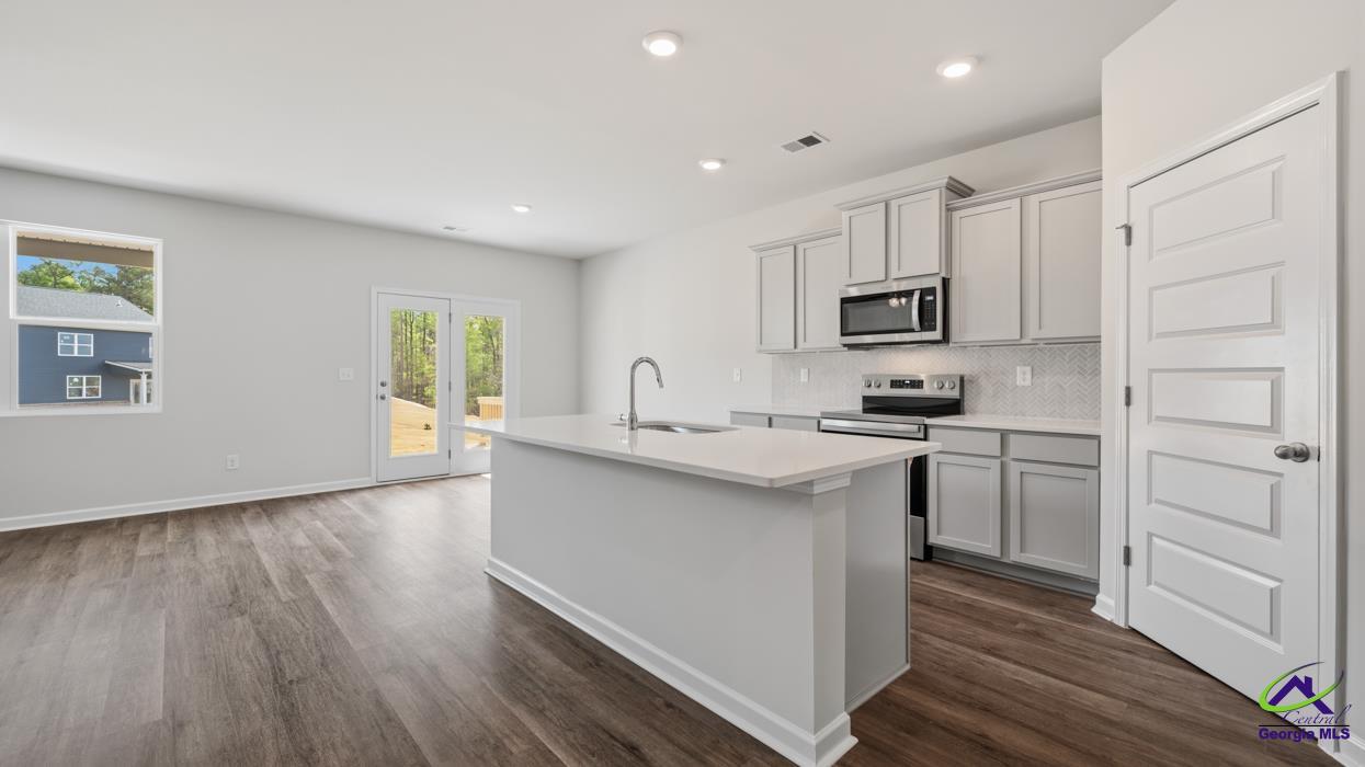 227 Cattle Drive Perry, GA 31069 - Photo 7 of 40 a kitchen with a sink cabinets and wooden floor