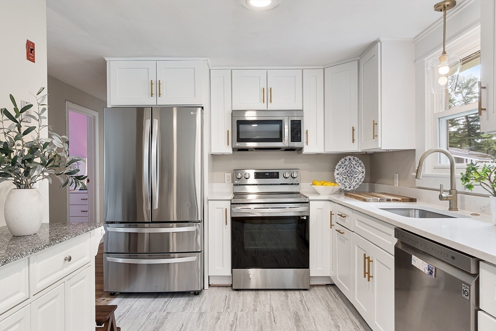 9 Springwell Road Billerica, MA 01821 - Photo 12 of 37 a kitchen with appliances a sink and cabinets