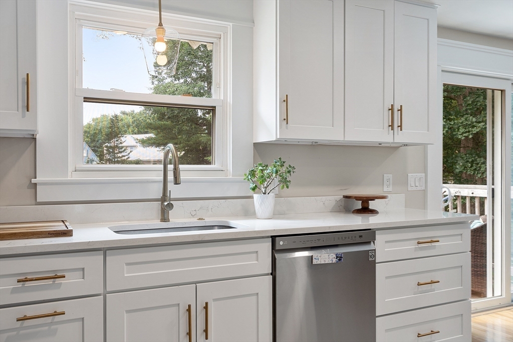 9 Springwell Road Billerica, MA 01821 - Photo 13 of 37 a kitchen with granite countertop white cabinets and a window