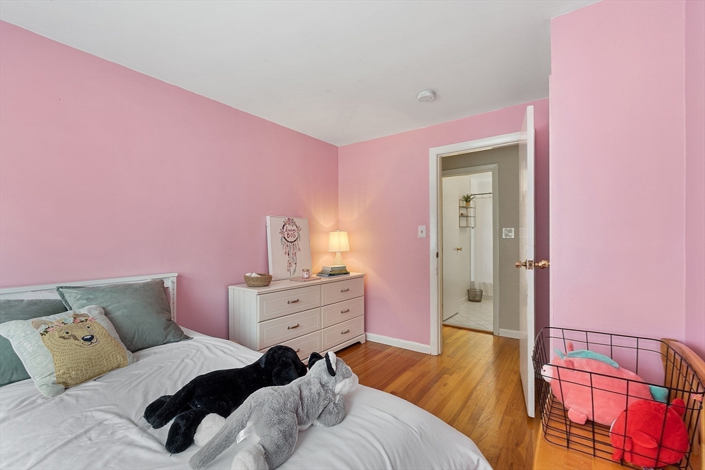 9 Springwell Road Billerica, MA 01821 - Photo 16 of 37 a bedroom with a bed and wooden floor