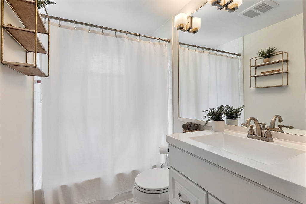9 Springwell Road Billerica, MA 01821 - Photo 17 of 37 a bathroom with a sink a toilet and a mirror