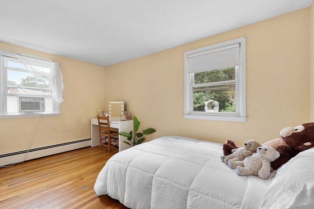 9 Springwell Road Billerica, MA 01821 - Photo 20 of 37 a bedroom with a bed and wooden floor