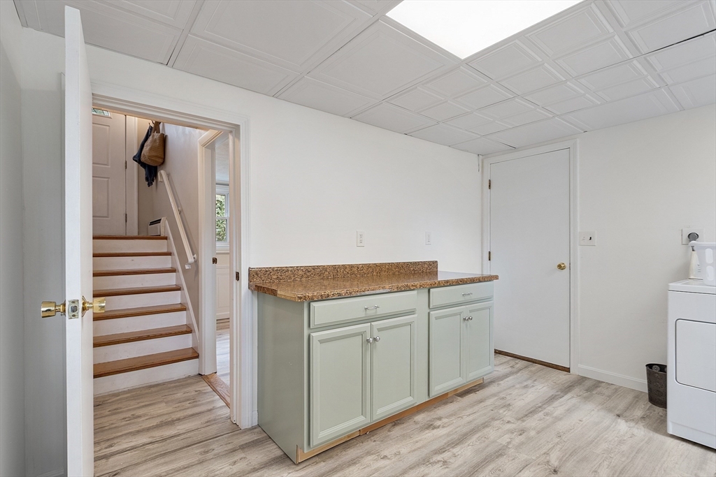 9 Springwell Road Billerica, MA 01821 - Photo 29 of 37 a view of a kitchen with white cabinets and wooden floor